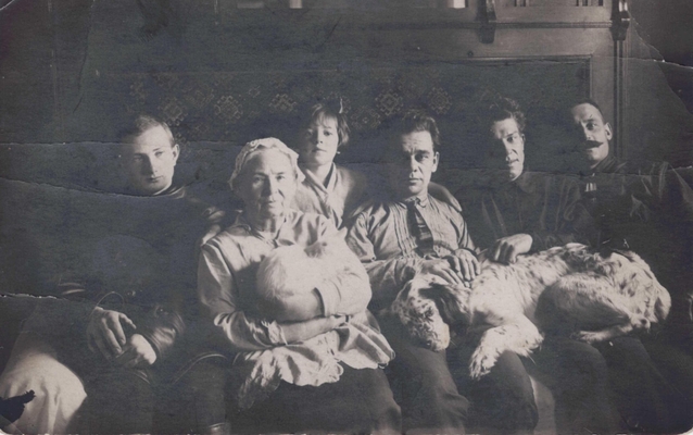 Фотография семьи Лызловых. Москва сер. 20-х годов. На диване - неизвестный, няня с кошкой, А.М. Лызлова - дочь, Лызлов М.И., Павел Сергеевич, Порфирий Степанович, на коленях у них собака